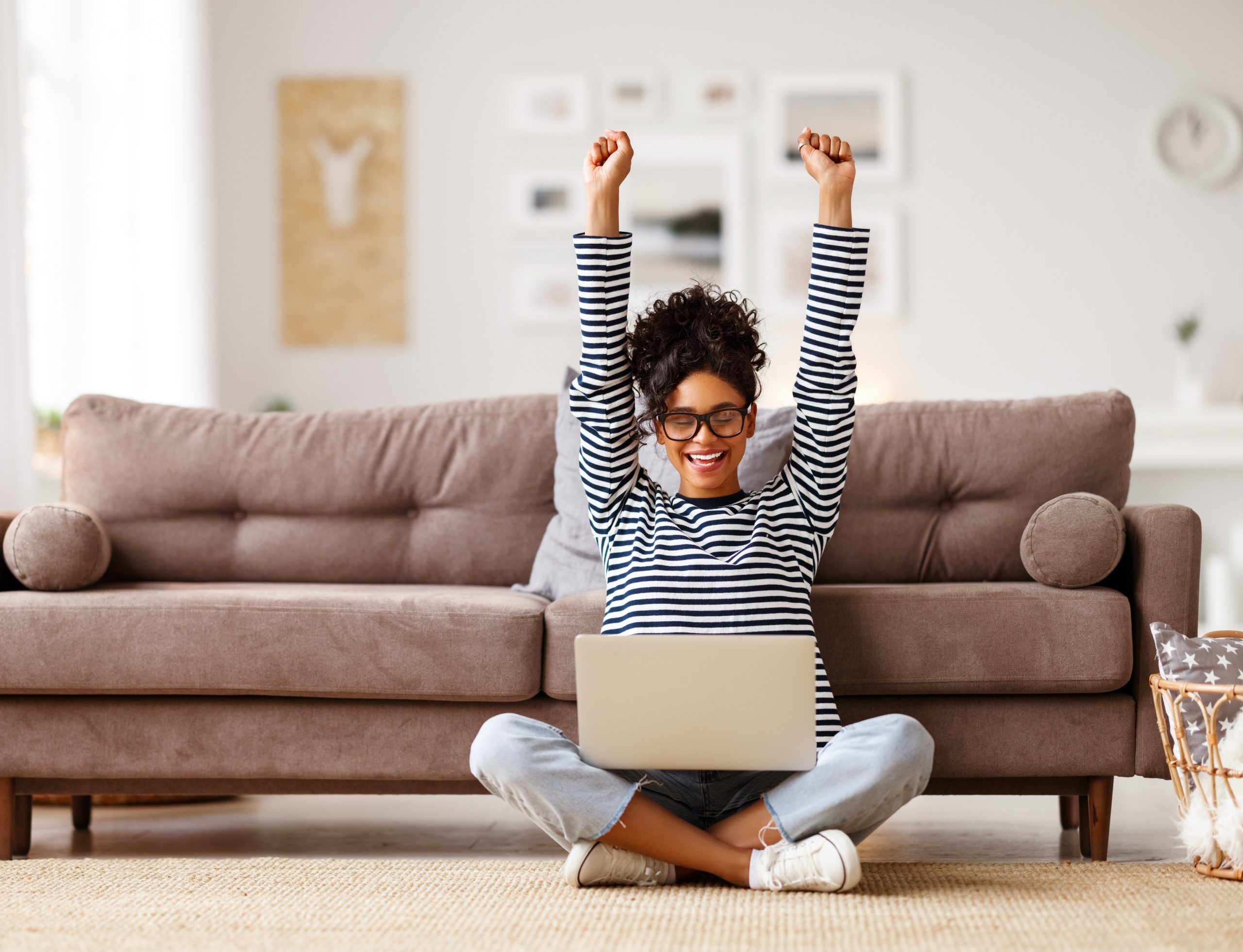 Joyful woman celebrating her manifestation success, representing the power of achieving goals through intention.