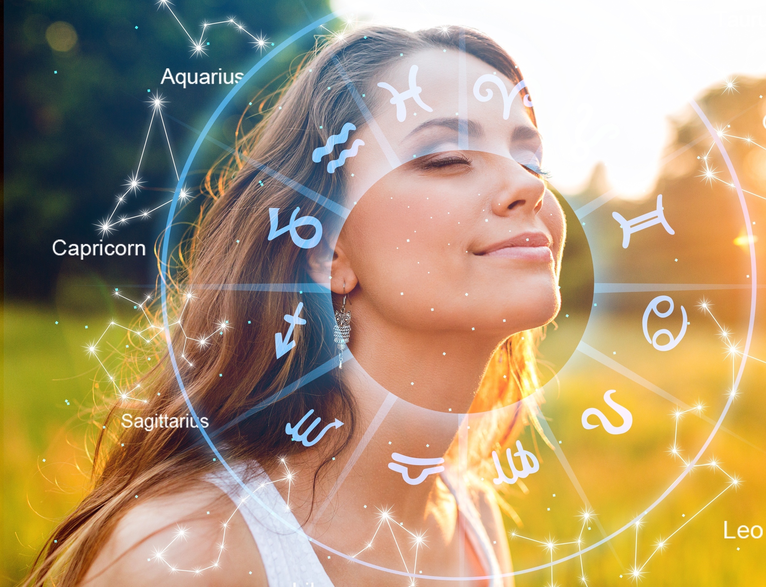 Astrology symbols with a woman looking peaceful under a cosmic zodiac wheel.